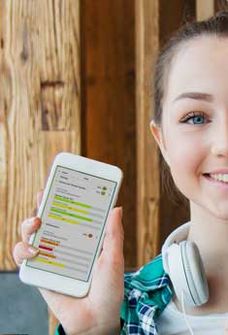 A student holds up her mobile phone showing the Options tool in use.